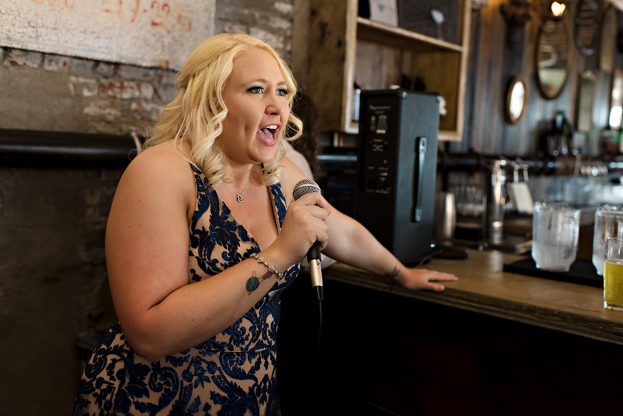 A bridesmaid telling jokes about the newly married couple.